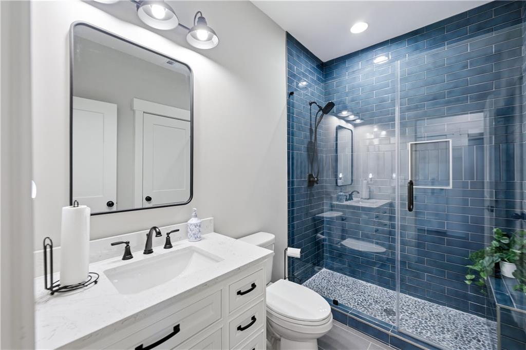 3584 Stock Road Monroe, GA 30656 - Photo 32 of 80 a bathroom with a sink a toilet a mirror and shower