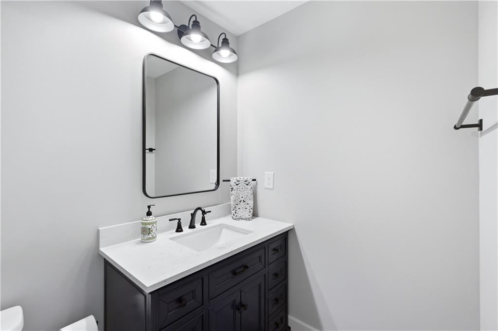 3584 Stock Road Monroe, GA 30656 - Photo 46 of 80 a bathroom with a sink vanity and a mirror