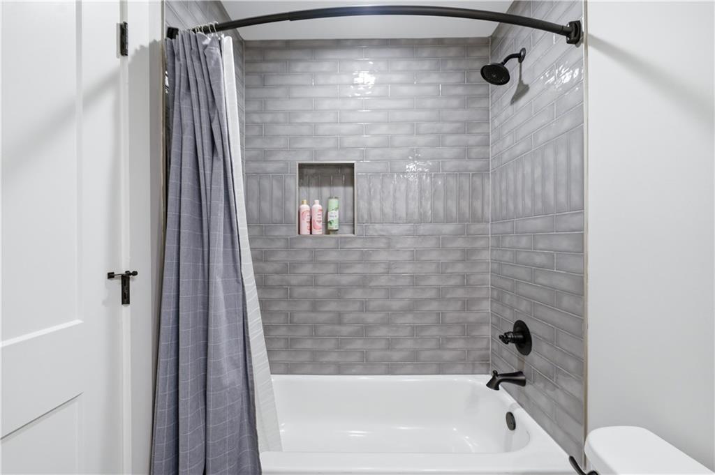 3584 Stock Road Monroe, GA 30656 - Photo 47 of 80 a bathroom with a shower a bathtub and a shower