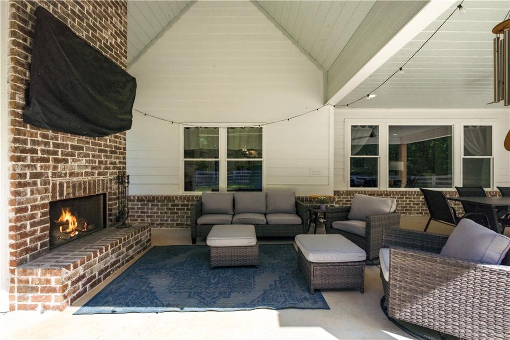 3584 Stock Road Monroe, GA 30656 - Photo 56 of 80 a living room with furniture a fireplace and window
