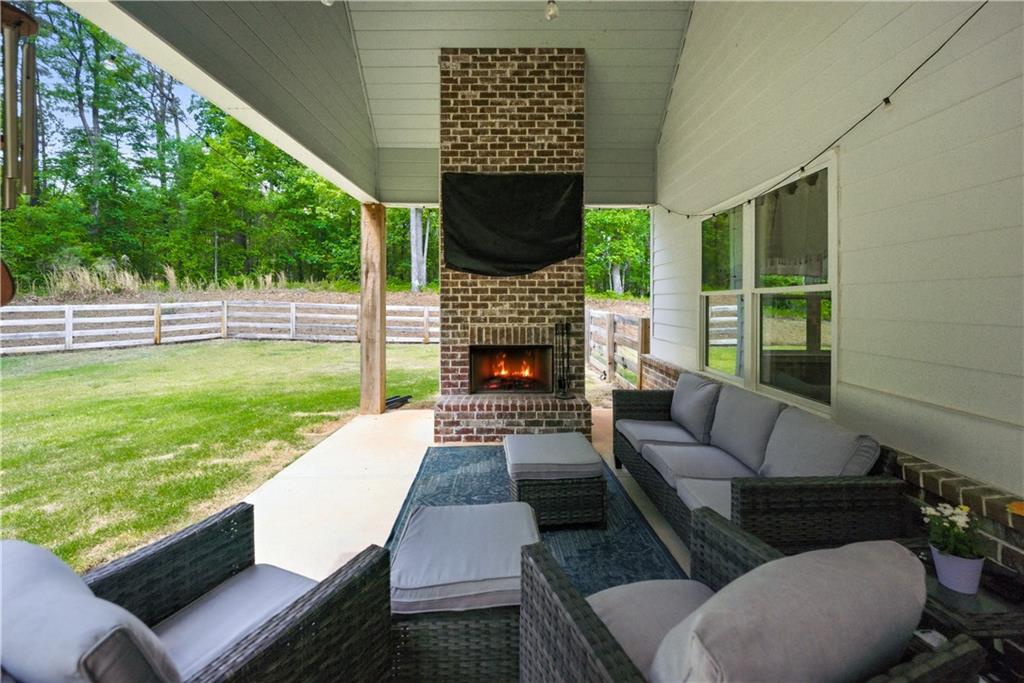 3584 Stock Road Monroe, GA 30656 - Photo 57 of 80 a living room with fireplace furniture and a large window