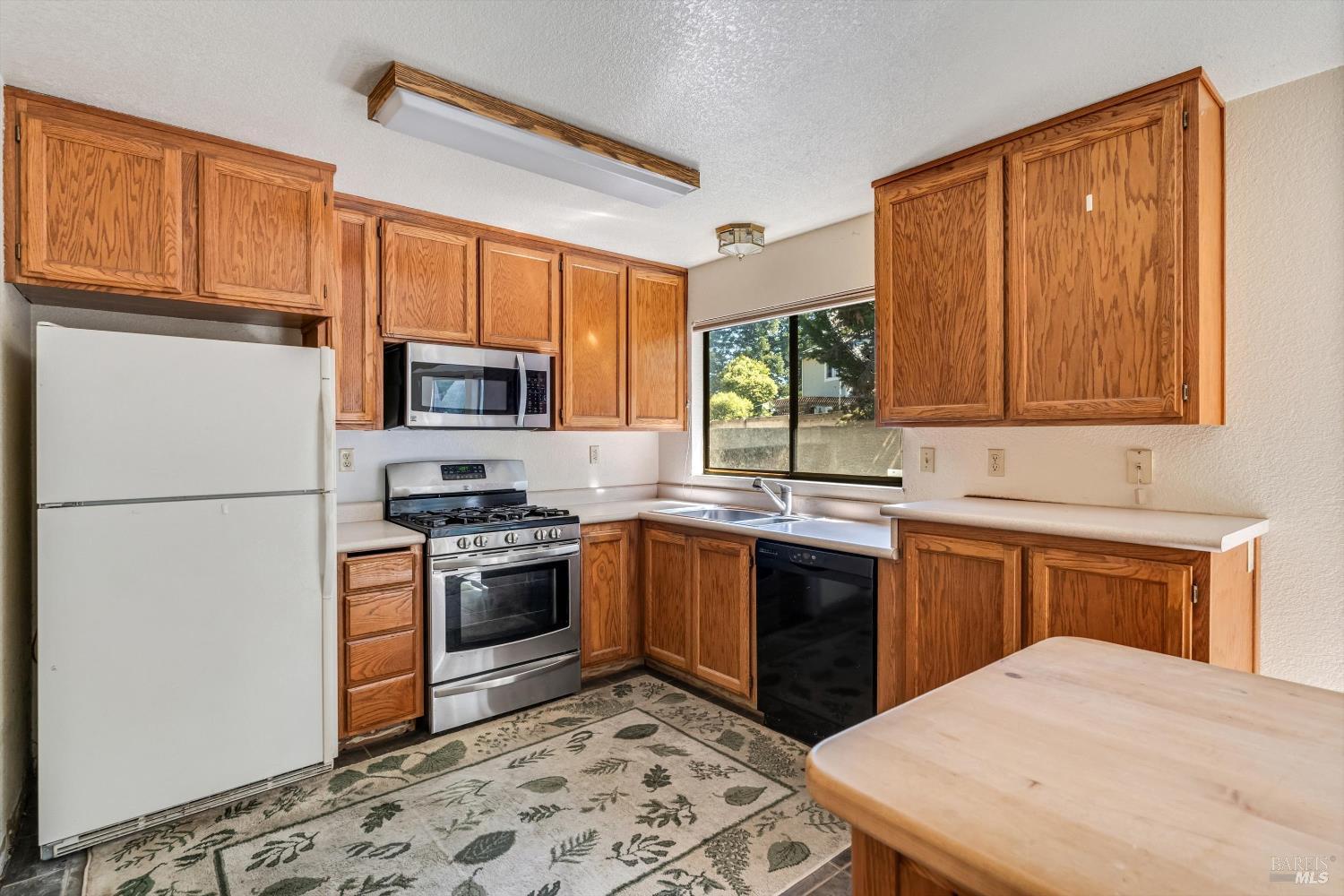 7408 Maximillian Place Rohnert Park, CA 94928 - Photo 6 of 19 Original finishes present an opportunity for buyers to create their dream kitchen while building equity. The practical layout offers a solid foundation for future improvements.