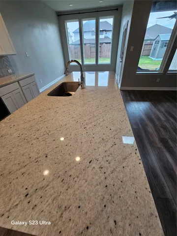 a view of wooden floor in a kitchen