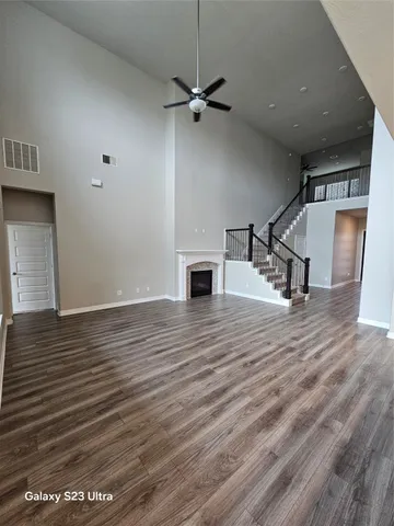 wooden floor in an empty room with a fireplace