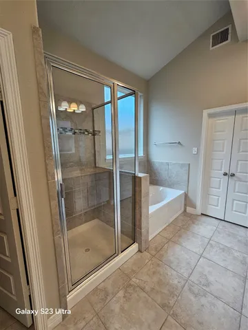 a large bathroom with a sink a large mirror and a shower