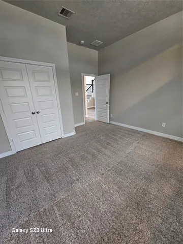 a bathroom with a granite countertop sink toilet a mirror and shower