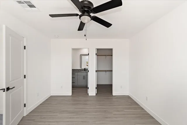 a view of empty room with wooden floor
