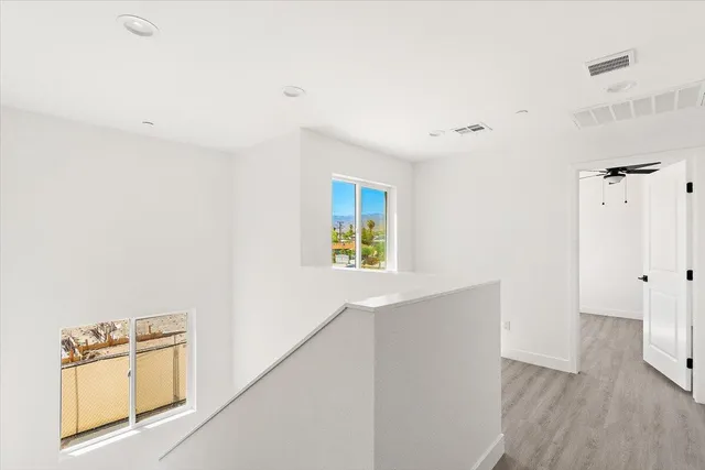 an empty room with wooden floor and a window