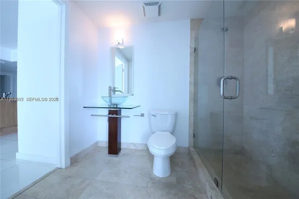 a bathroom with a shower and toilet