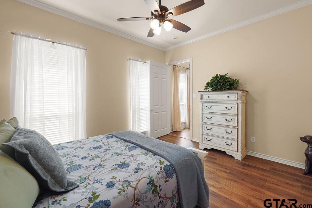 2210 Homestead Lane Tyler, TX 75701 - Photo 15 of 26 a bedroom with a bed and a dresser