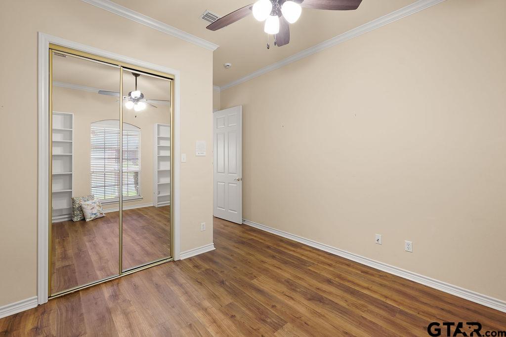 2210 Homestead Lane Tyler, TX 75701 - Photo 21 of 26 an empty room with wooden floor mirror and window