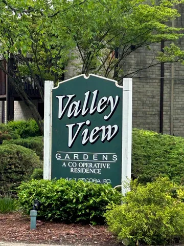 a sign broad in front of a brick building
