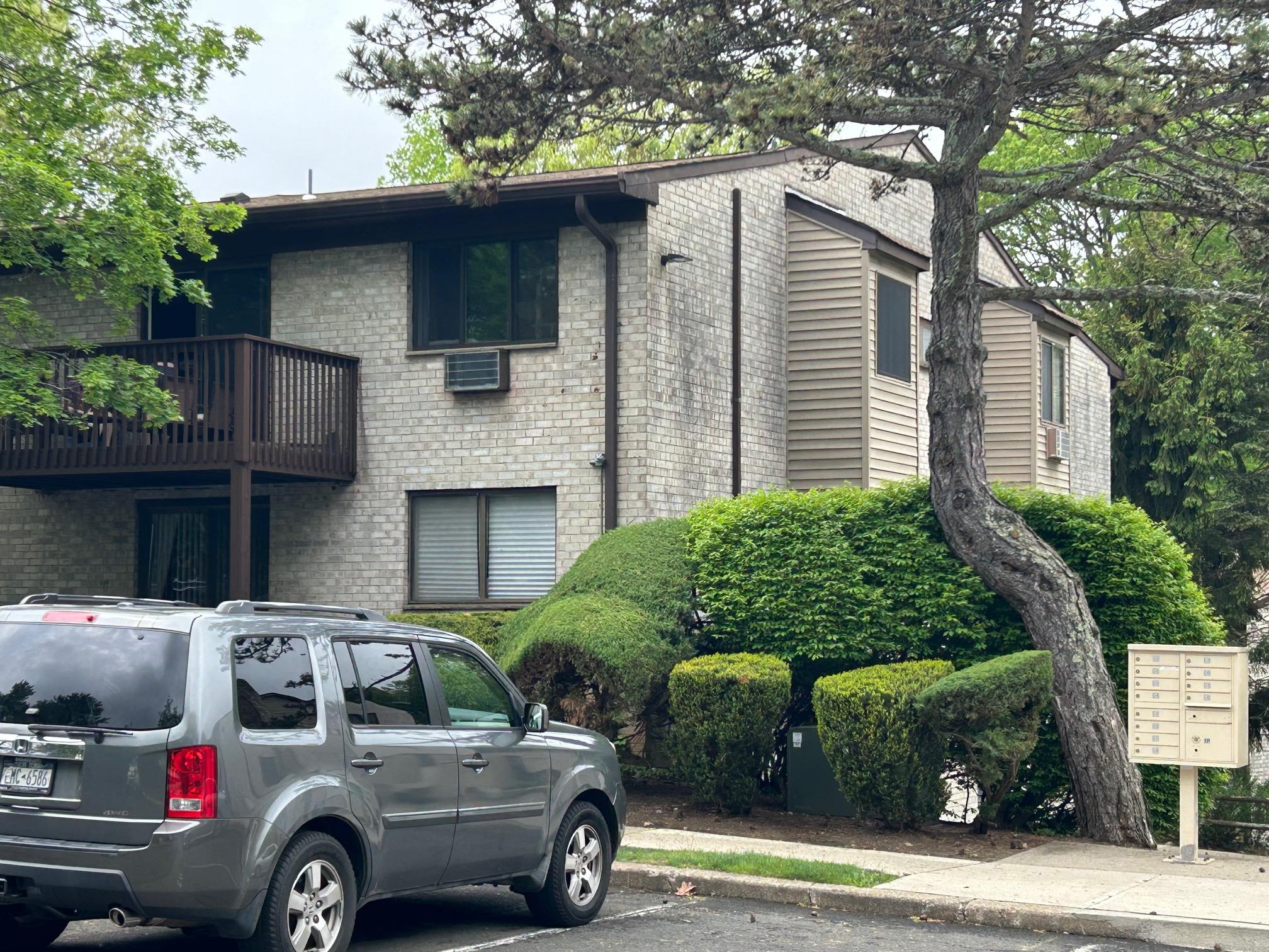 2 Secora Road, Unit C20 Monsey, NY 10952 - Photo 2 of 34 a front view of a house with parking area