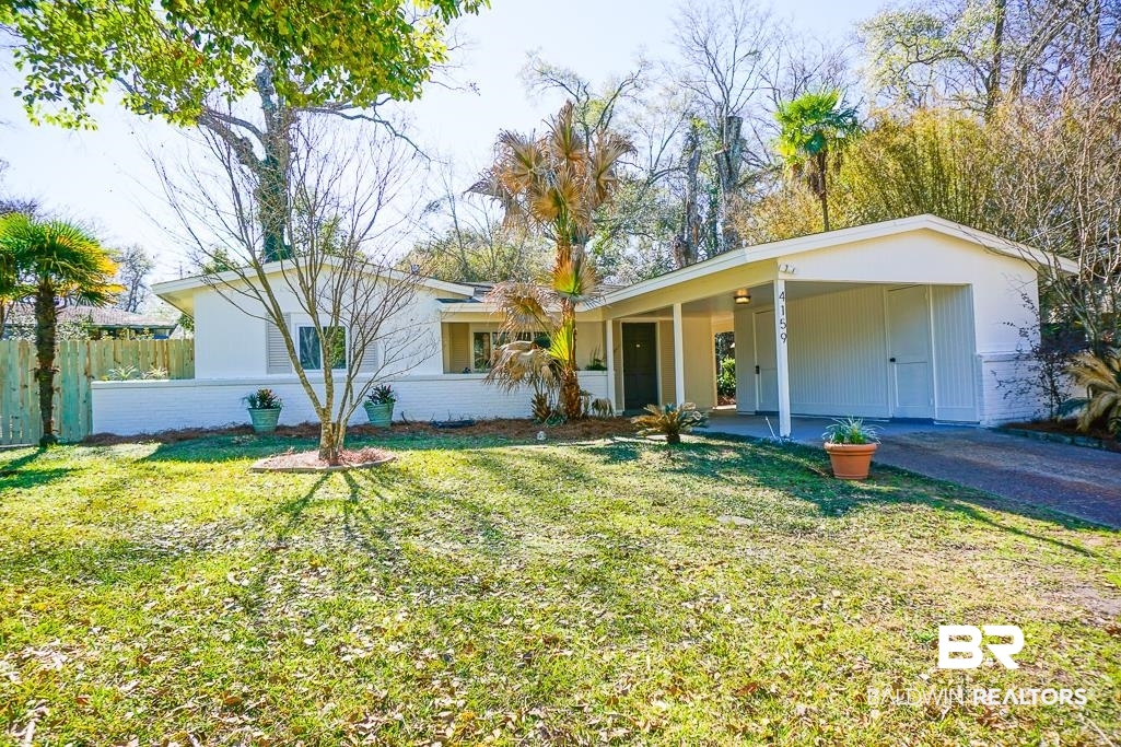 4159 Rebecca Road Mobile, AL 36609 - Photo 1 of 19 Ranch-style house featuring a front yard, brick siding, fence, and an attached carport