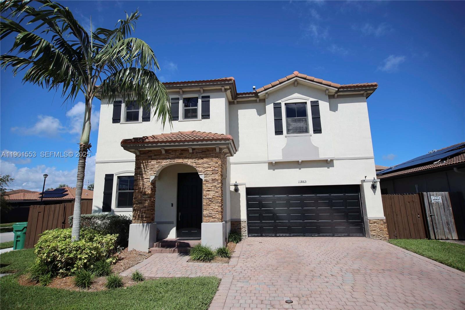 a front view of a house with yard and parking