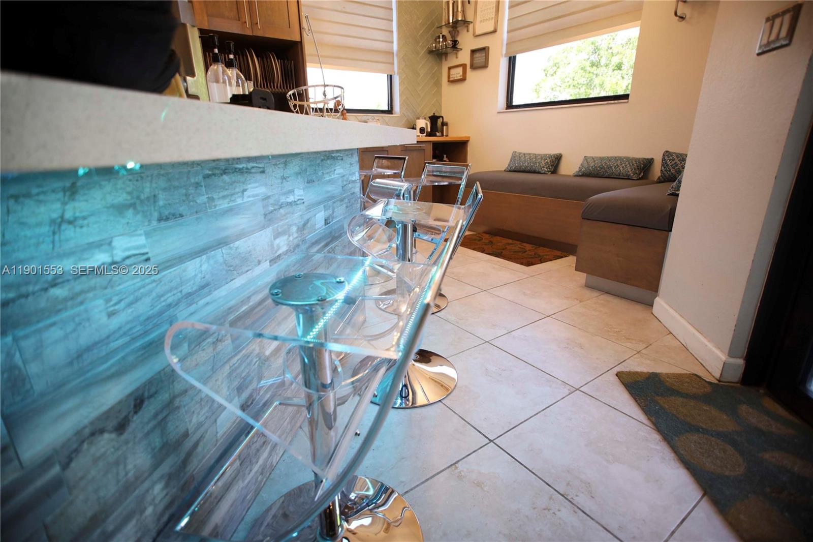 11863 Southwest 233rd Terrace Homestead, FL 33032 - Photo 20 of 77 a living room with couches and kitchen view with wooden floor