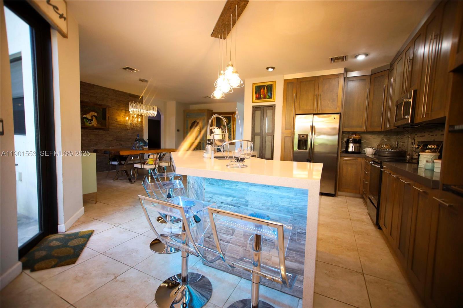 11863 Southwest 233rd Terrace Homestead, FL 33032 - Photo 30 of 77 a large kitchen with kitchen island a sink stainless steel appliances and cabinets