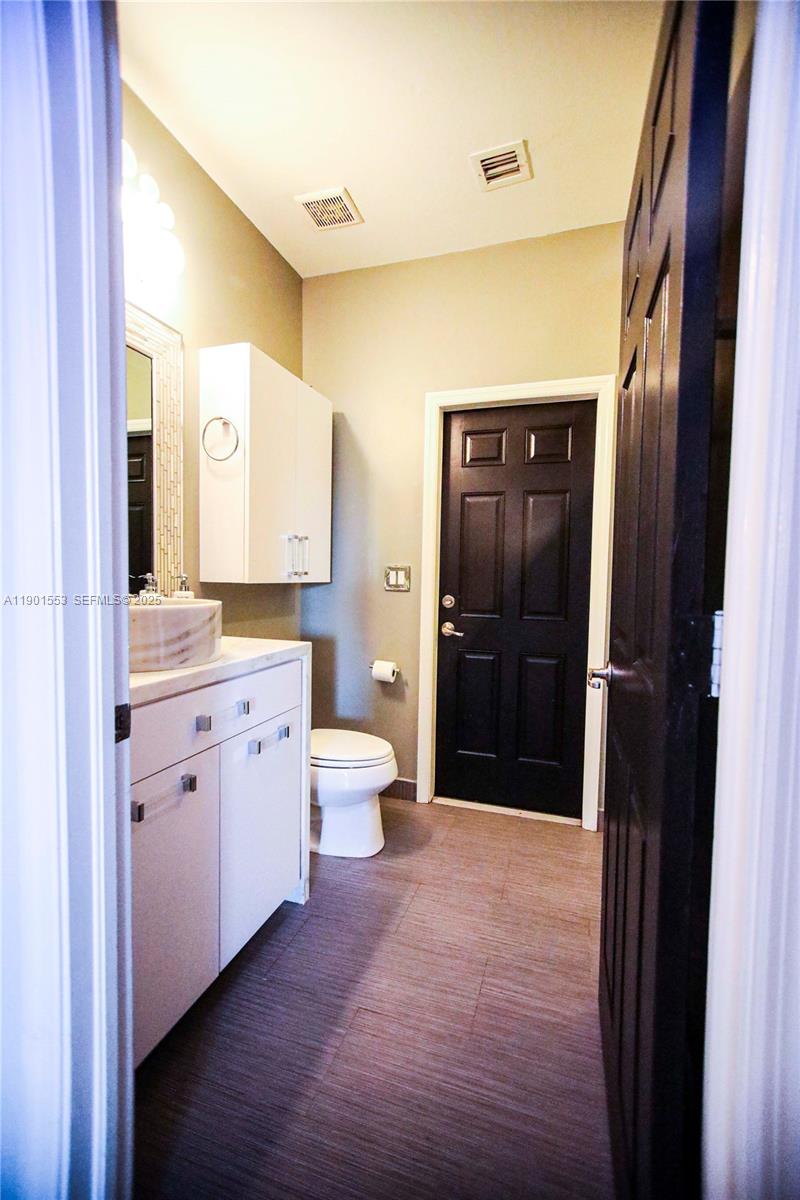 11863 Southwest 233rd Terrace Homestead, FL 33032 - Photo 38 of 77 a large bathroom with a sink a toilet and shower