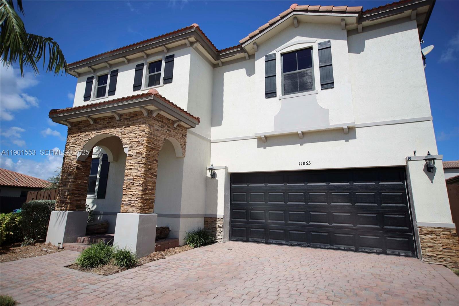 11863 Southwest 233rd Terrace Homestead, FL 33032 - Photo 4 of 77 a front view of a house with a yard