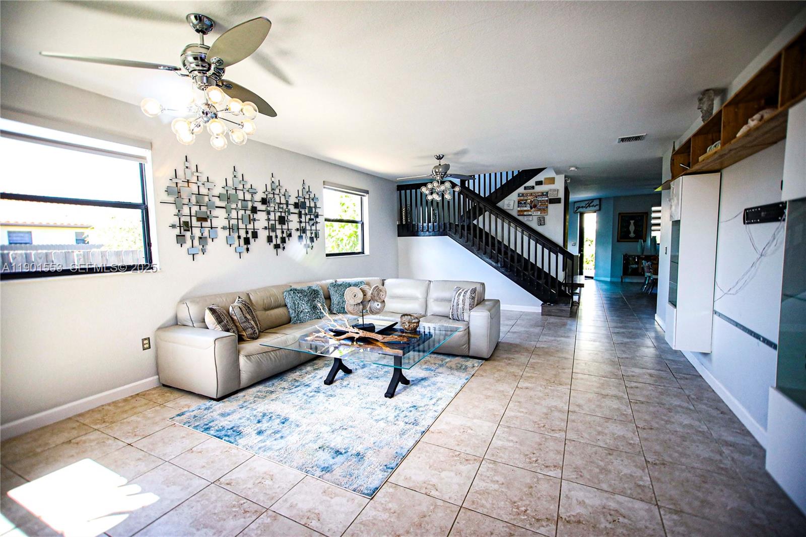 11863 Southwest 233rd Terrace Homestead, FL 33032 - Photo 5 of 77 a living room with furniture and a chandelier
