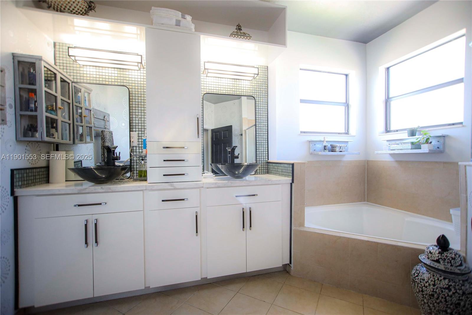 11863 Southwest 233rd Terrace Homestead, FL 33032 - Photo 54 of 77 a bathroom with a tub a sink and a large window
