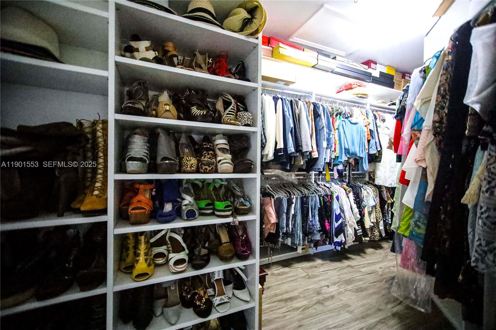 11863 Southwest 233rd Terrace Homestead, FL 33032 - Photo 55 of 77 a view of walk in closet with clothes and shoes