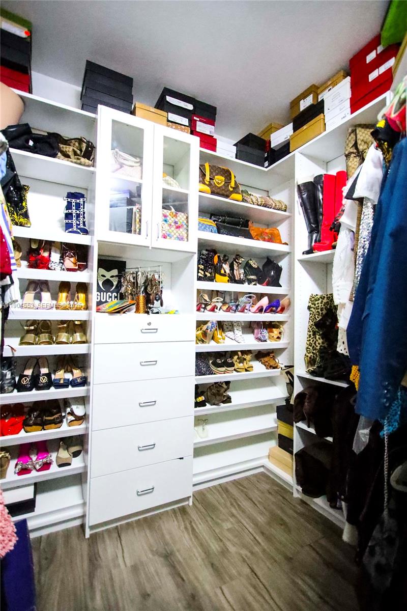 11863 Southwest 233rd Terrace Homestead, FL 33032 - Photo 56 of 77 a view of walk in closet with clothes and shoes