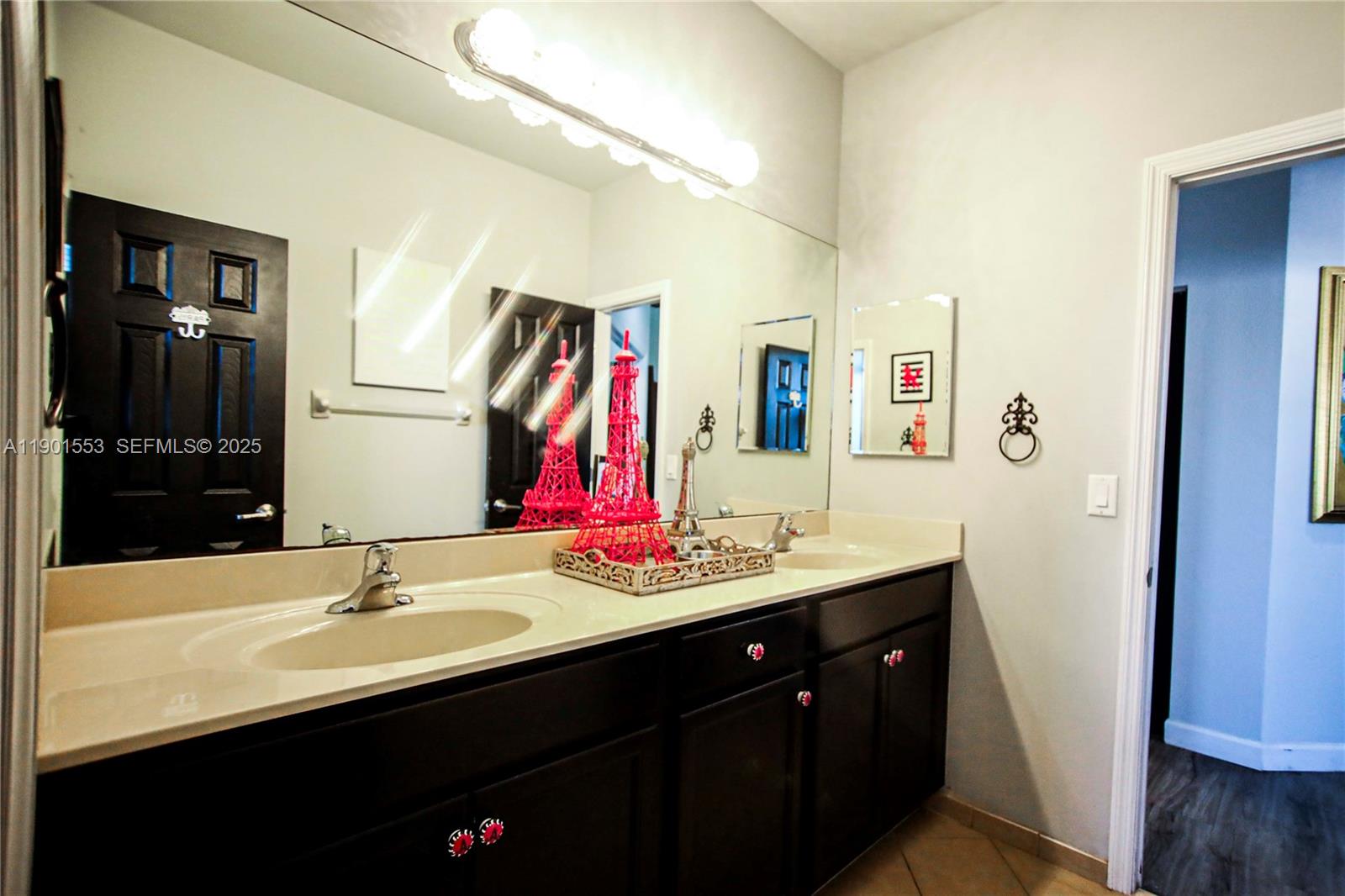 11863 Southwest 233rd Terrace Homestead, FL 33032 - Photo 60 of 77 a bathroom with a sink and a mirror