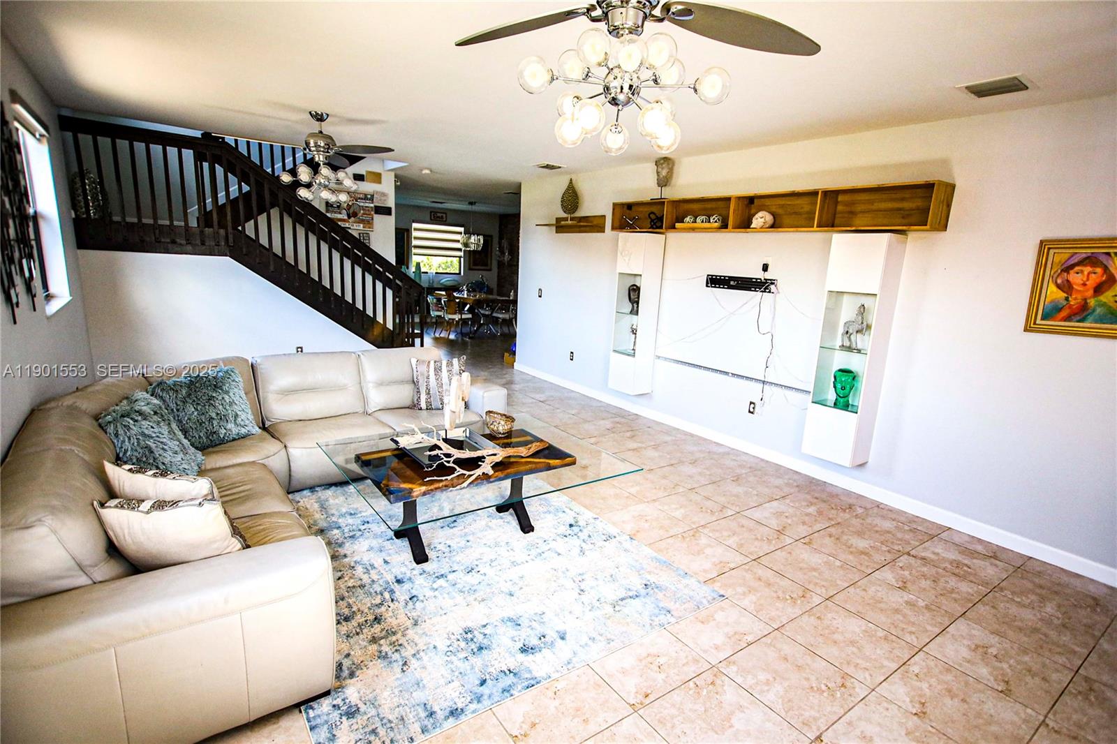 11863 Southwest 233rd Terrace Homestead, FL 33032 - Photo 6 of 77 a living room with furniture fireplace and a chandelier