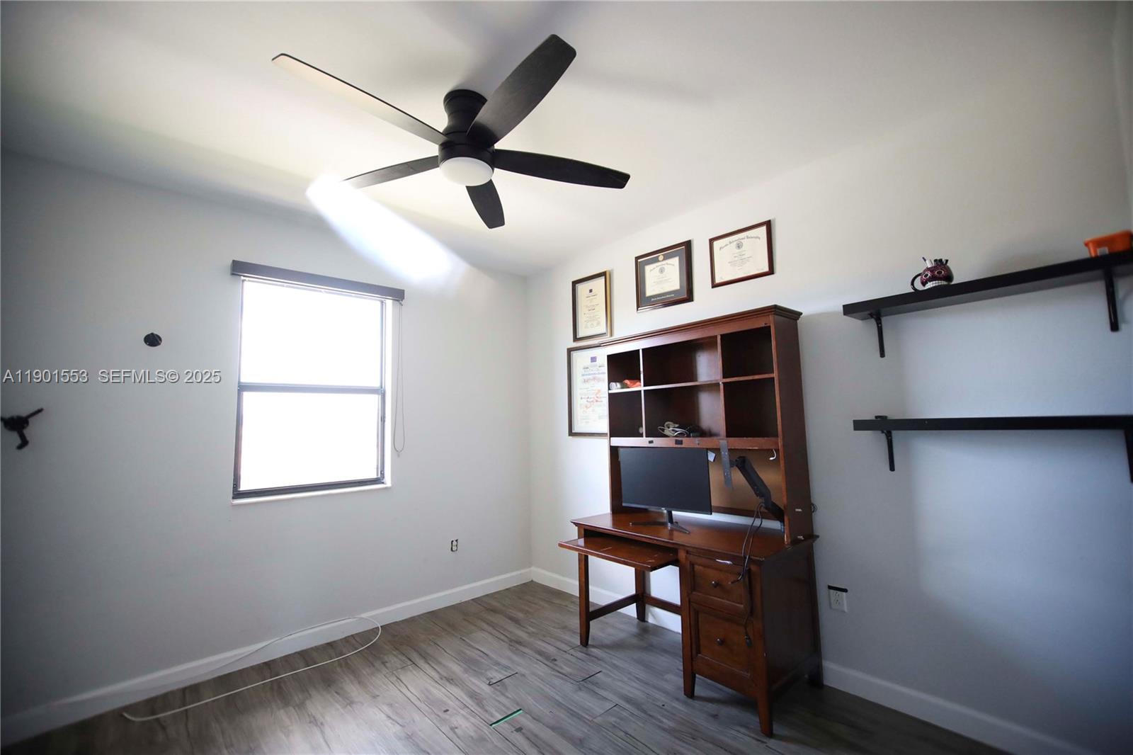 11863 Southwest 233rd Terrace Homestead, FL 33032 - Photo 64 of 77 a view of workspace with wooden floor and ceiling fan