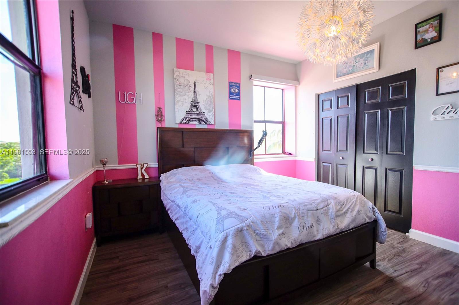 11863 Southwest 233rd Terrace Homestead, FL 33032 - Photo 65 of 77 a bedroom with a large bed and wooden floor