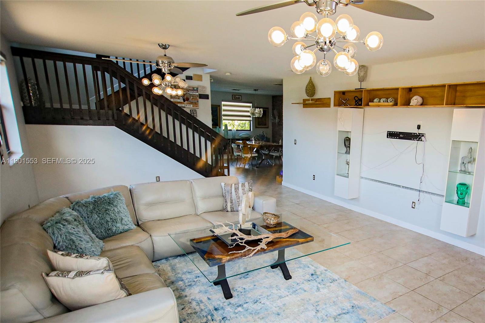 11863 Southwest 233rd Terrace Homestead, FL 33032 - Photo 7 of 77 a living room with furniture fireplace and a chandelier