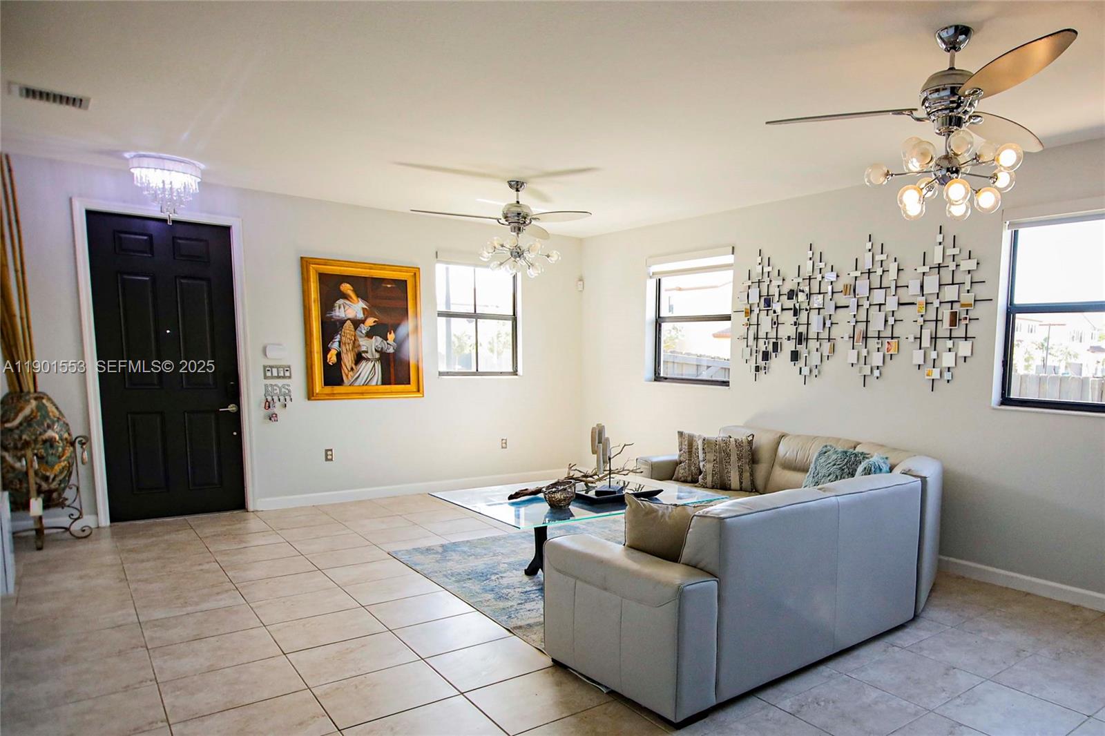 11863 Southwest 233rd Terrace Homestead, FL 33032 - Photo 10 of 77 a living room with furniture and a chandelier