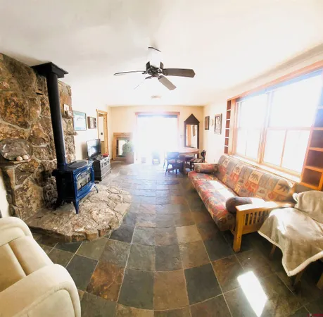 a kitchen with granite countertop a stove a sink and a refrigerator