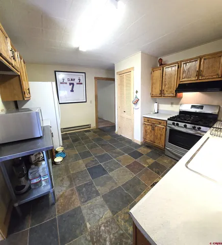 a kitchen with a stove a sink and a microwave