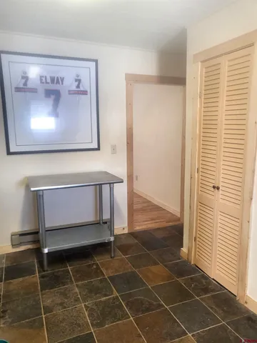 a kitchen with granite countertop a stove a sink and a refrigerator