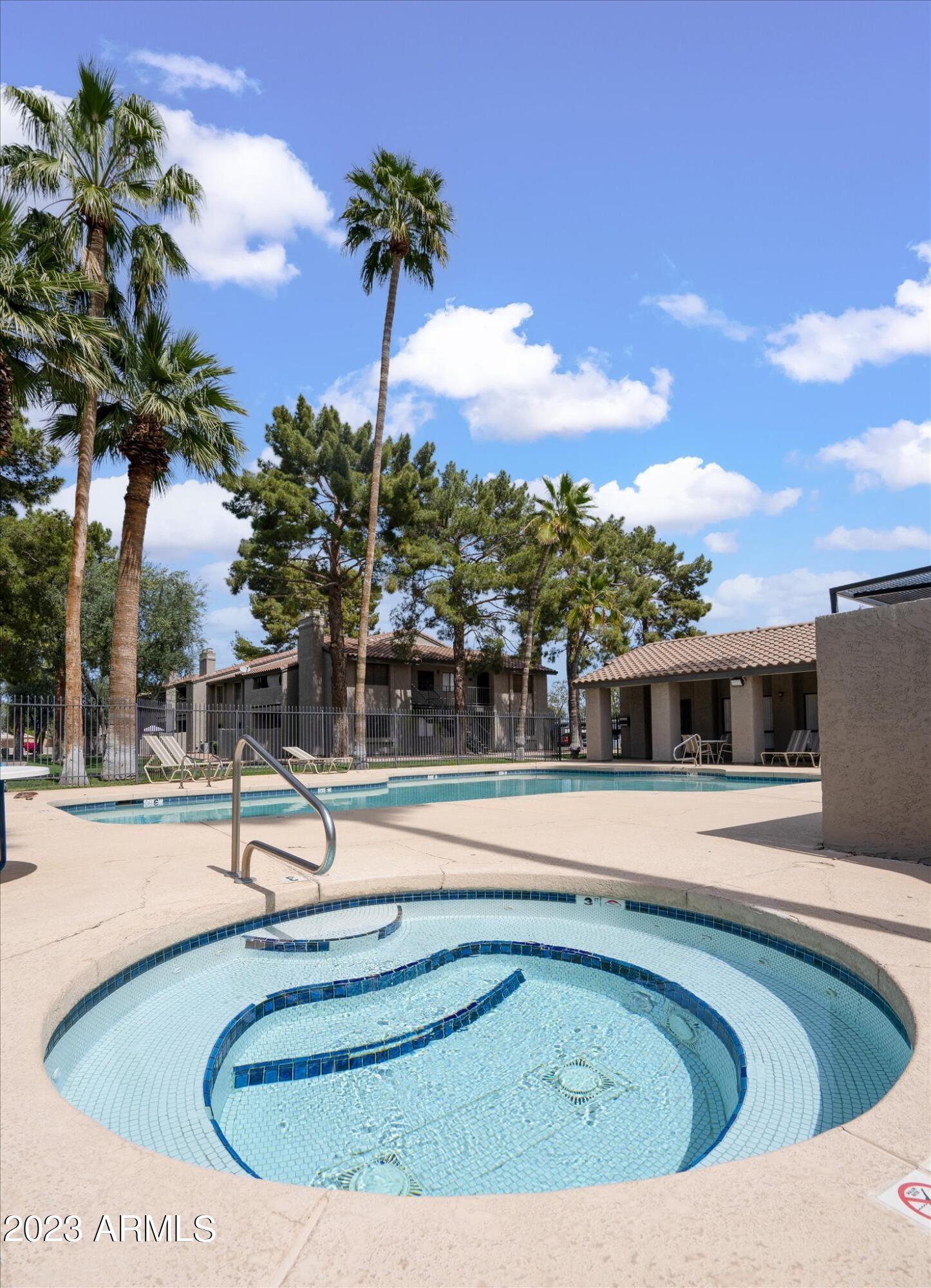 533 West Guadalupe Road, Unit 1024 Mesa, AZ 85210 - Photo 54 of 60 a view of a swimming pool with a house
