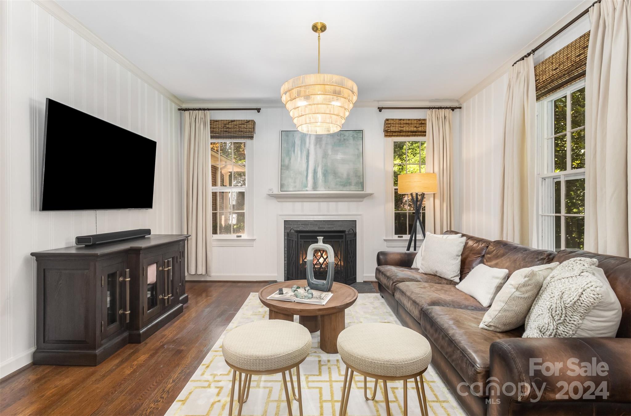 1900 South Wendover Road Charlotte, NC 28211 - Photo 15 of 38 a living room with furniture a flat screen tv and a fireplace