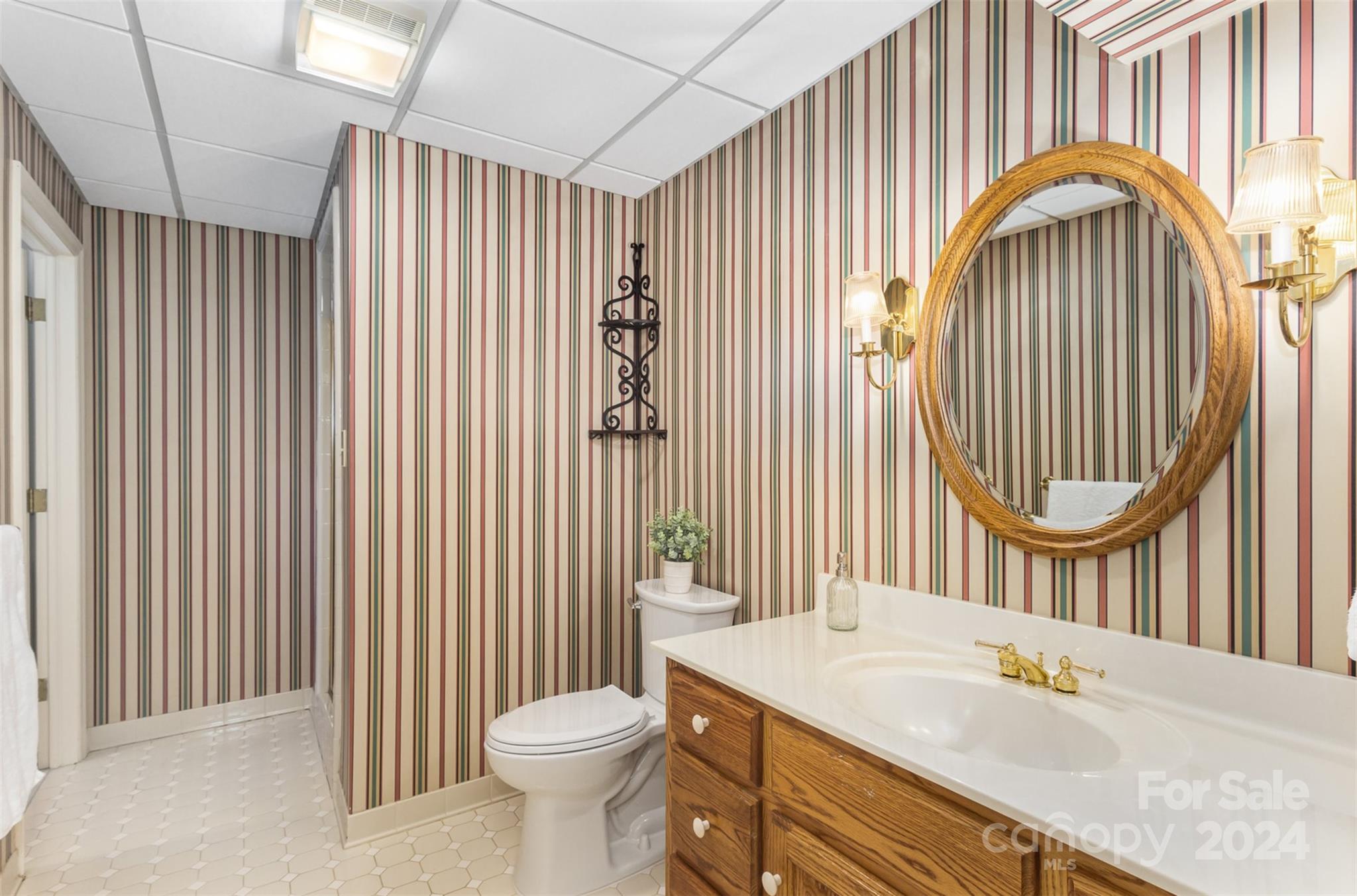 1900 South Wendover Road Charlotte, NC 28211 - Photo 27 of 38 a bathroom with a sink a toilet and a mirror