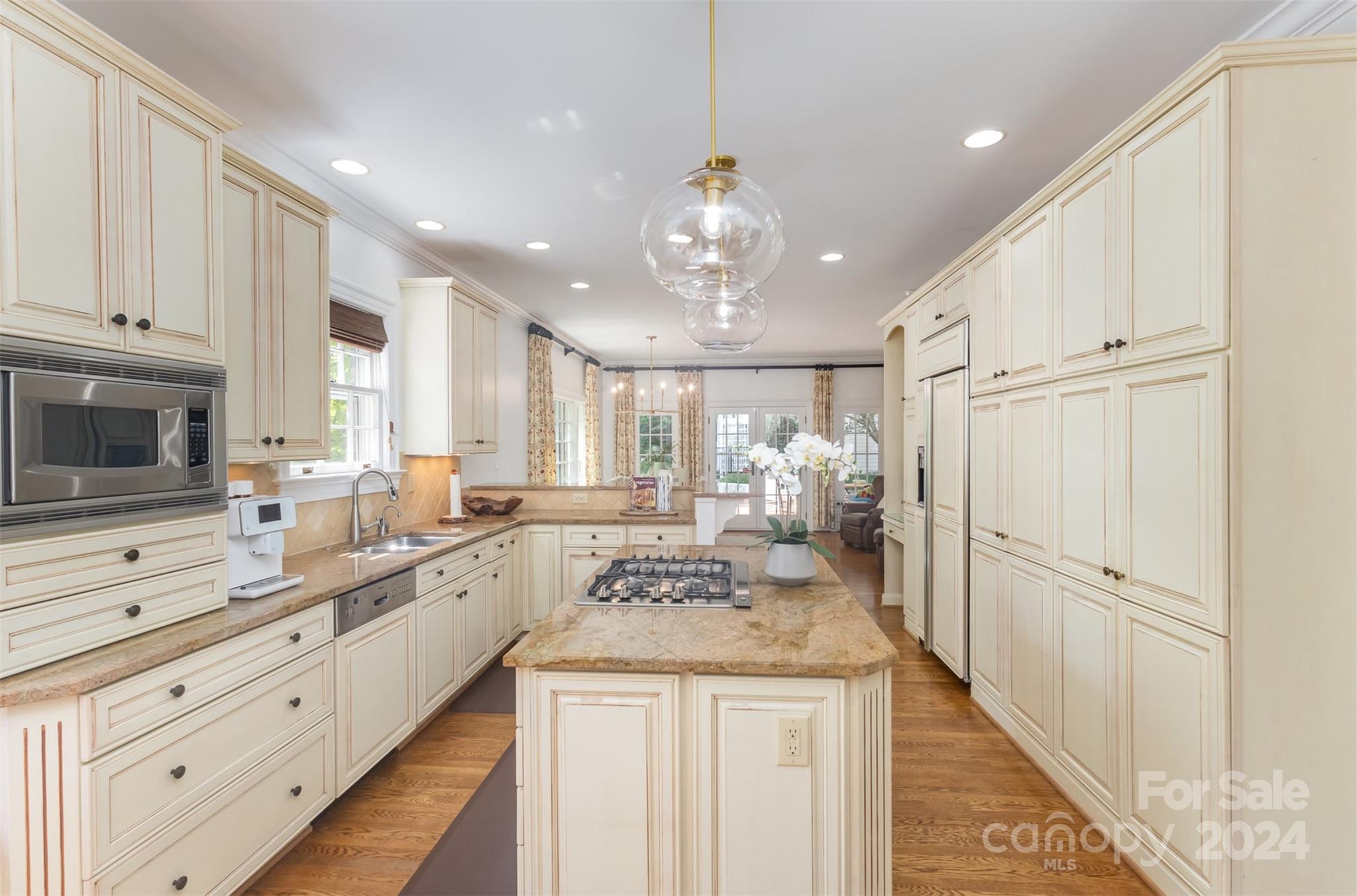 1900 South Wendover Road Charlotte, NC 28211 - Photo 9 of 38 a large white kitchen with a stove a sink dishwasher and a refrigerator with wooden floor