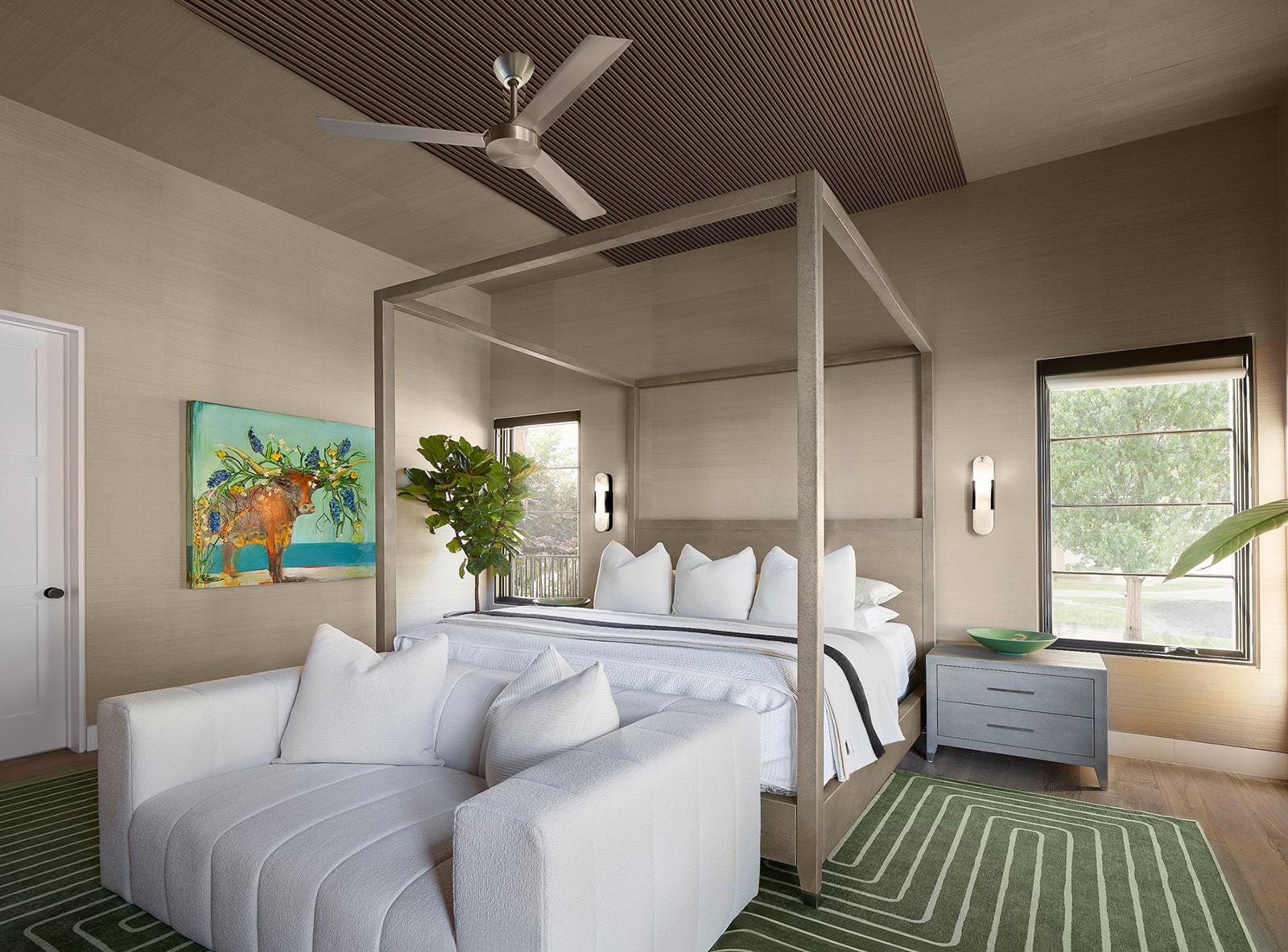 604 Brookhaven Trail Austin, TX 78746 - Photo 11 of 38 The primary bedroom retreat. Vaulted ceiling with slat panel accent, ceiling fan, and wall-mounted sconces surrounded by greenery and opening up to the pool.