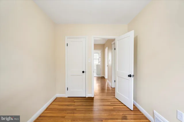 a view of a room with wooden floor and white doors