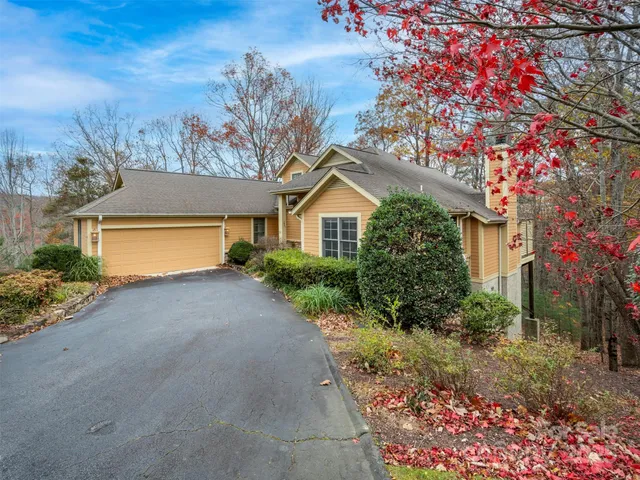 a view of a house with a tree in the background