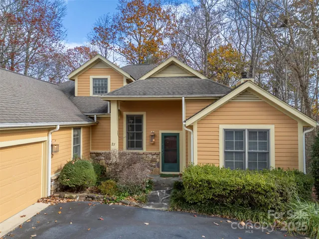 a view of a house with a yard and plants