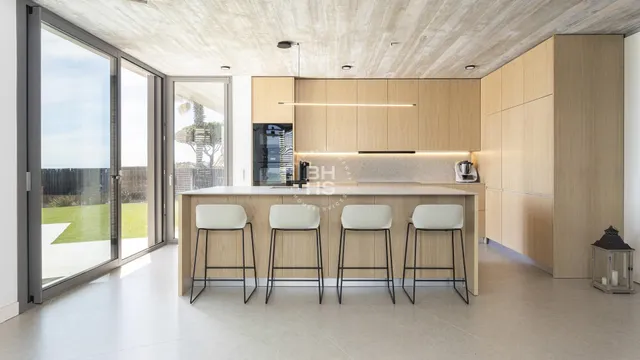 a kitchen with stainless steel appliances granite countertop a table and chairs in it