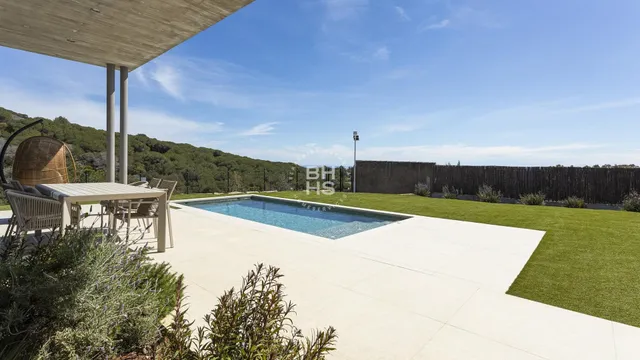 a view of a swimming pool with a lawn chairs and a yard
