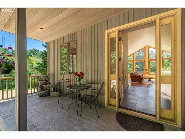 a living room with furniture large window and a fireplace