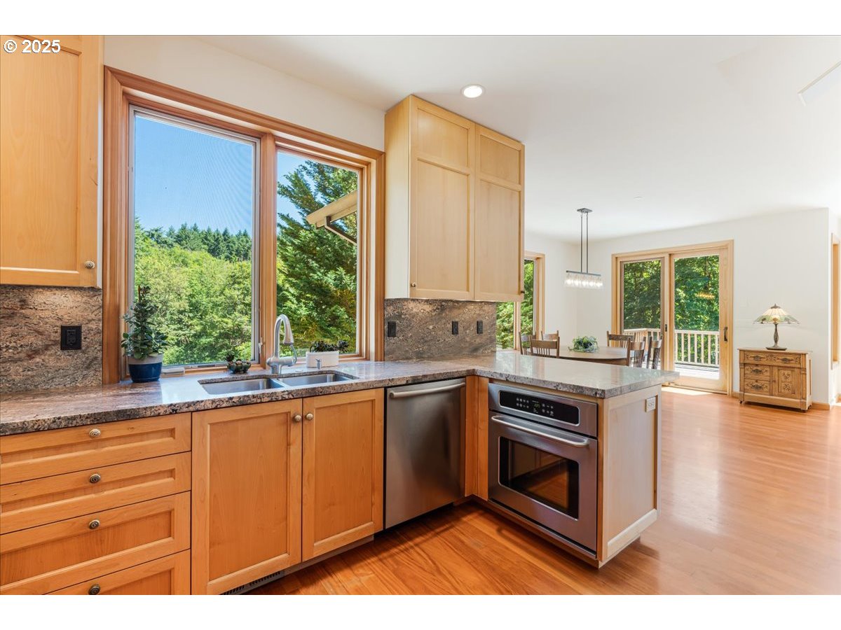 22500 Northwest Pihl Road Banks, OR 97106 - Photo 23 of 47 a kitchen with stainless steel appliances granite countertop a stove a sink and a microwave