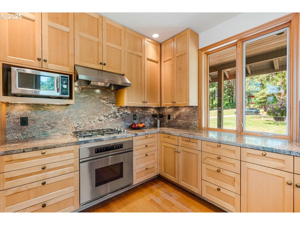 22500 Northwest Pihl Road Banks, OR 97106 - Photo 24 of 47 a kitchen with stainless steel appliances granite countertop a stove a sink and a microwave
