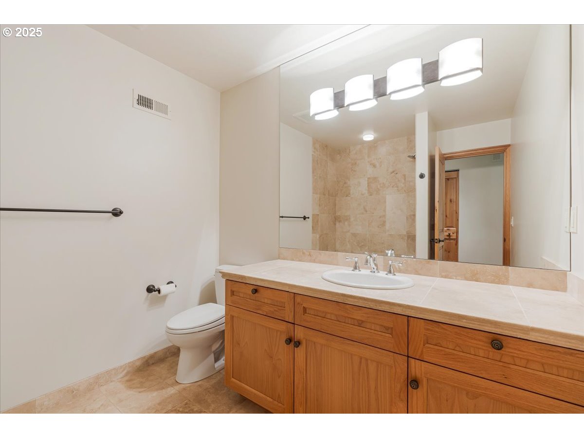 22500 Northwest Pihl Road Banks, OR 97106 - Photo 30 of 47 a bathroom with a toilet a sink and mirror